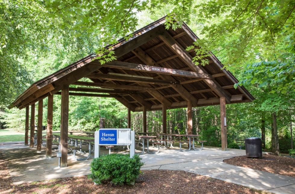 View of parks largest sized wooden picnic shelter with picnic tables