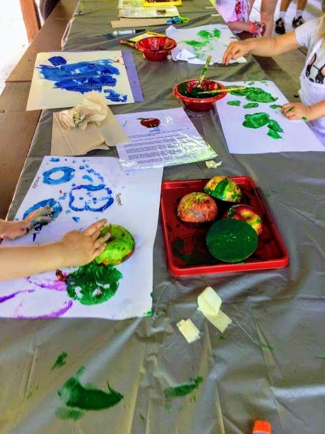 fruit and paint spread out on picnic table