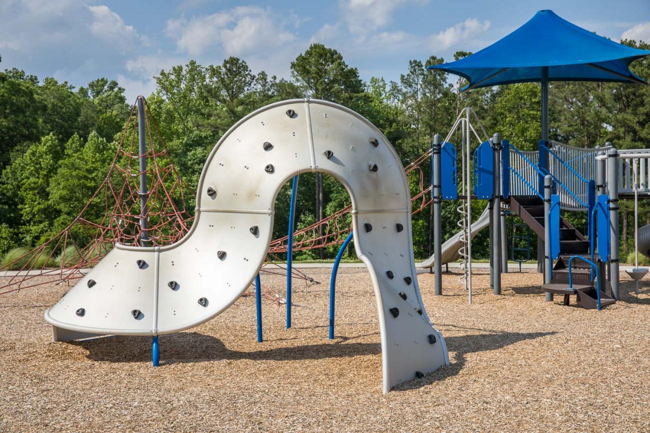 Climbing wall with play structure in the background