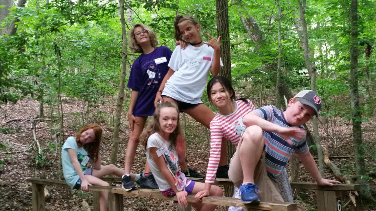 Older elementary aged campers striking a funny pose for the camera