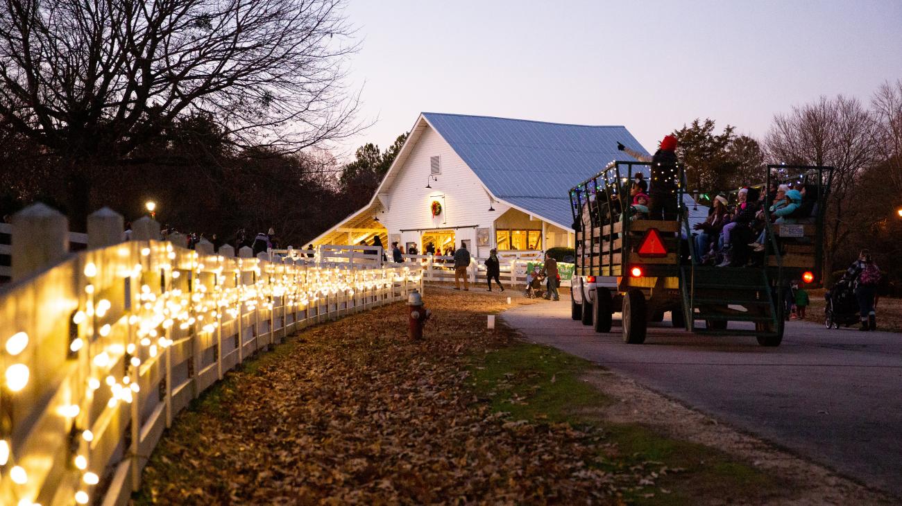 Night shot of the Livestock Barn during Sleigh Rides event with holiday lights