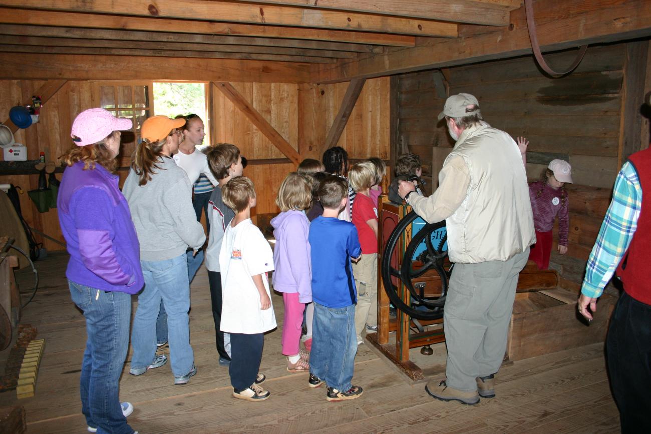 tour group stands inside of old historic mill building