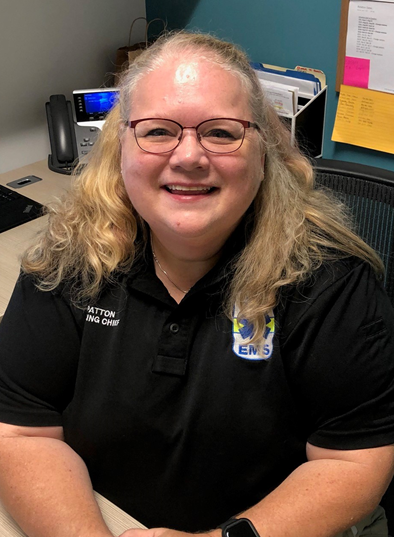 Tammy Patton smiling at her desk