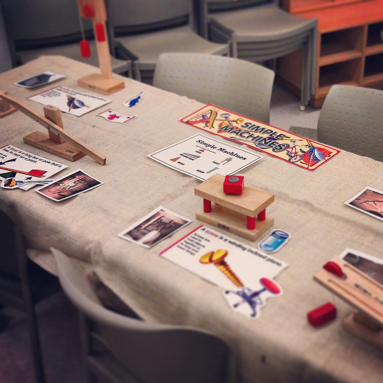 wooden simple machines models (pulley, lever, wheel) on table