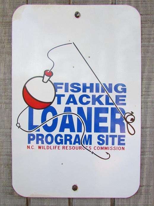 Photo of the Tackle Loaner metal sign on the shed which contains the park's fishing supplies