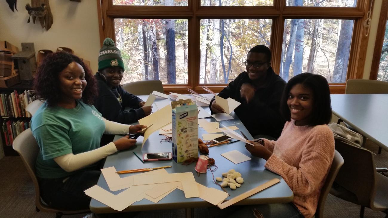 High school volunteers folding brochures and prepapring craft materials at Blue Jay Point