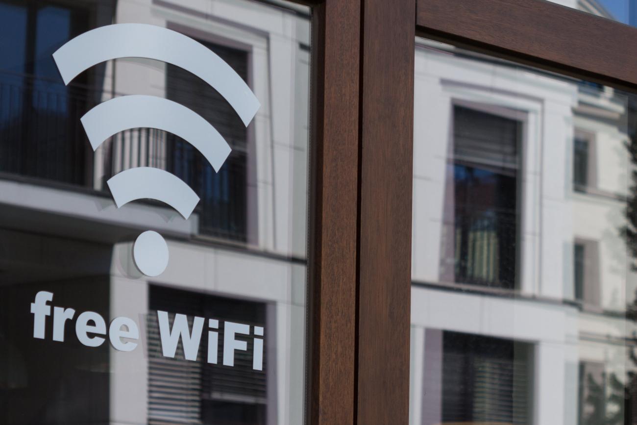 an office building in the background with a Wi-Fi symbol overlayed onto it