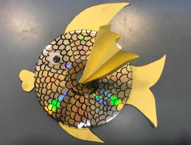 compact disc with googly eyes and fins to look like fish