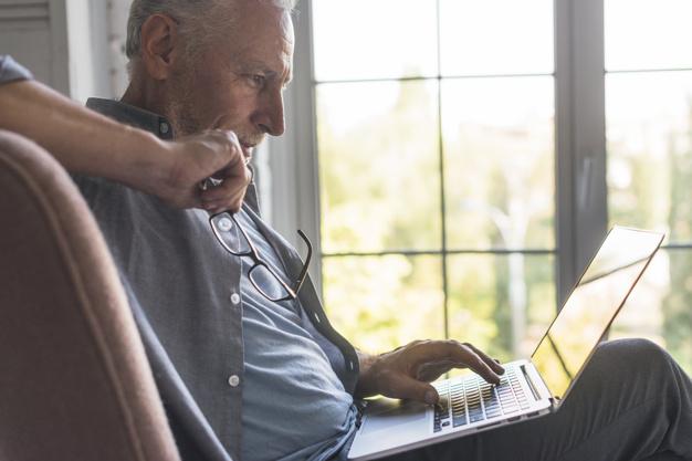 Older gentleman viewing information on a computer.