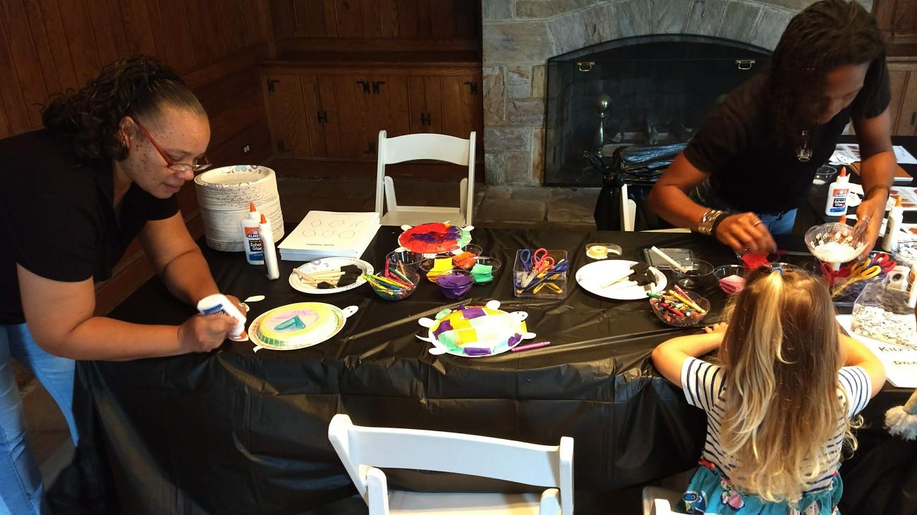 Volunteers running a craft table at an Oak View event