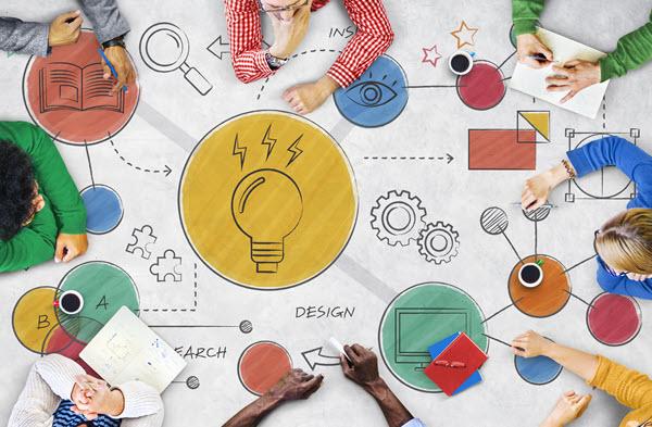 view from above, people around a table with idea, tech and innovation-related illustrations