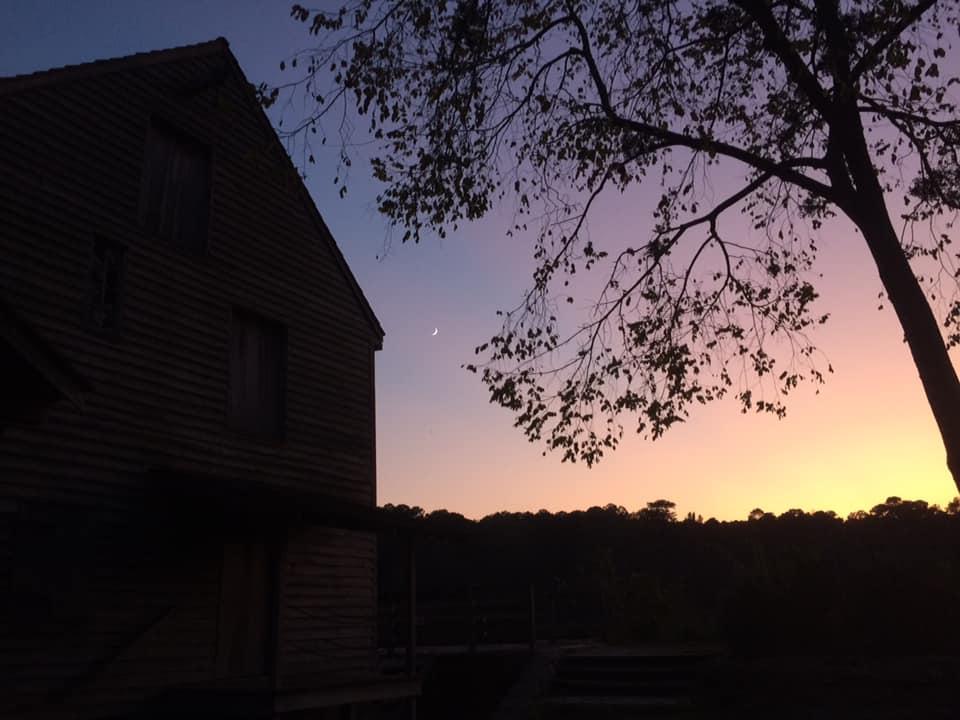 silhouette of mill building at sunset