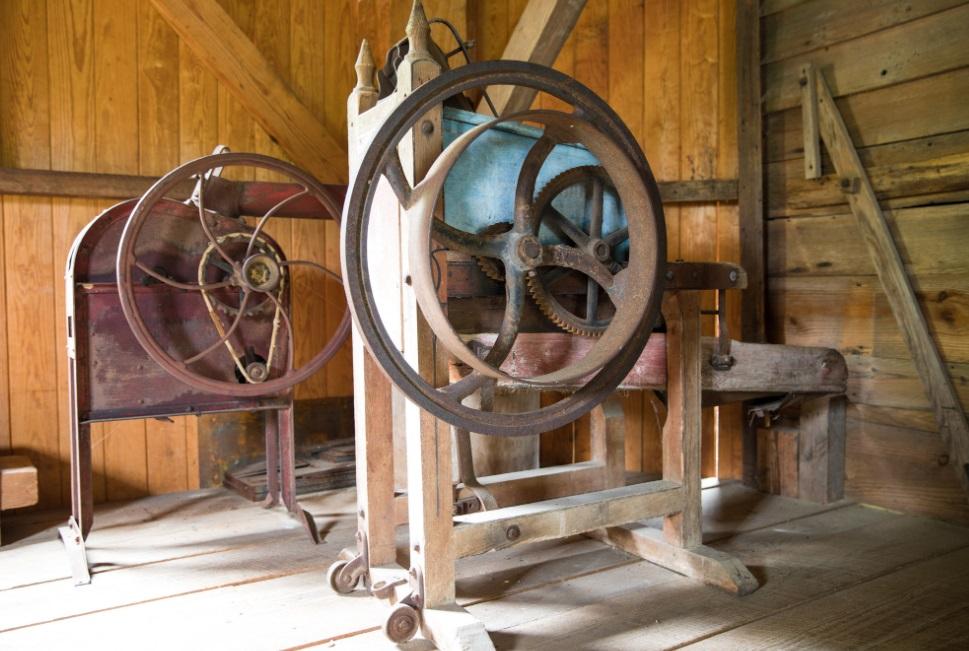 old mill equipment inside of old wooden mill building