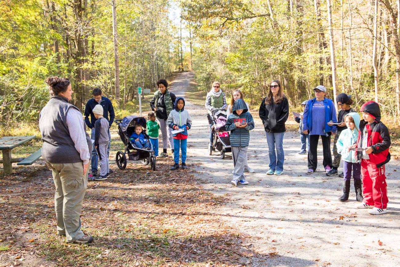 A photo of families listening to an instructor at a Family Program on the American Tobacco Trail