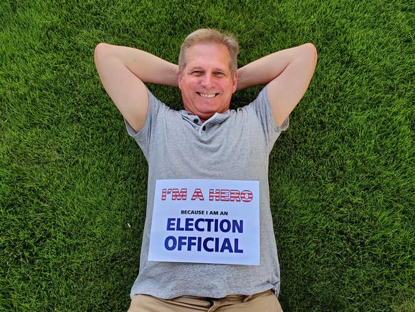 Election Official relaxing on green grass.