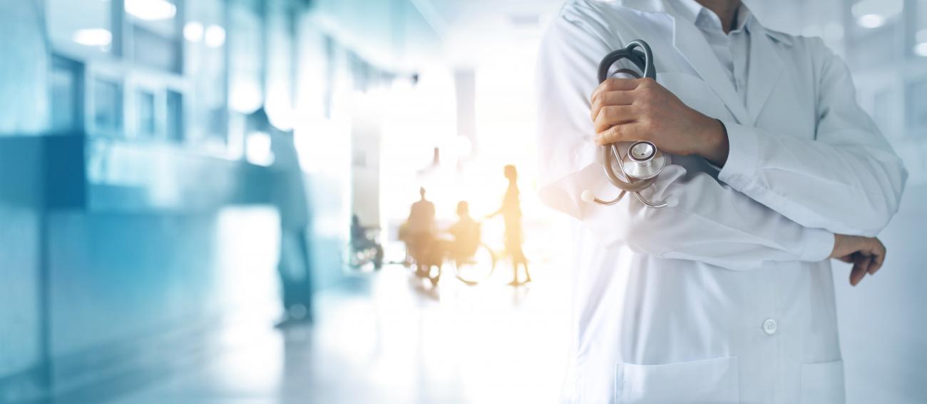 Public Health setting with doctor holding a stethoscope in hand