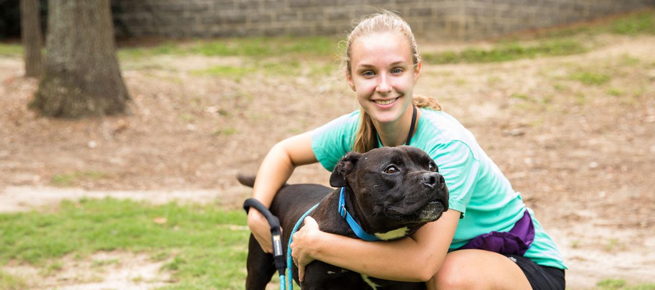 Woman hugging dog