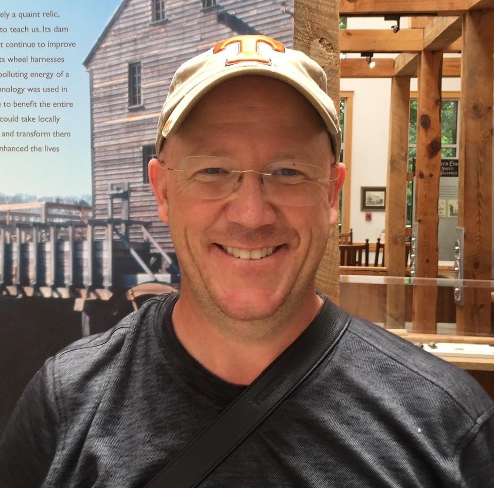 picture of park volunteer with ball cap on inside of exhibit hall