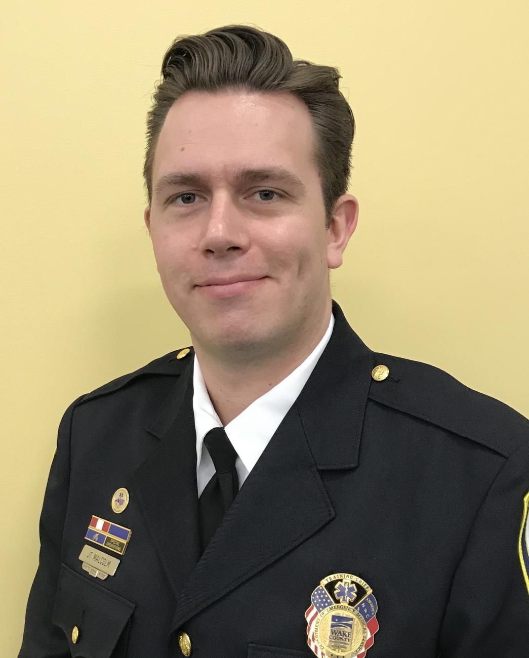 JT Malcolm smiling in uniform