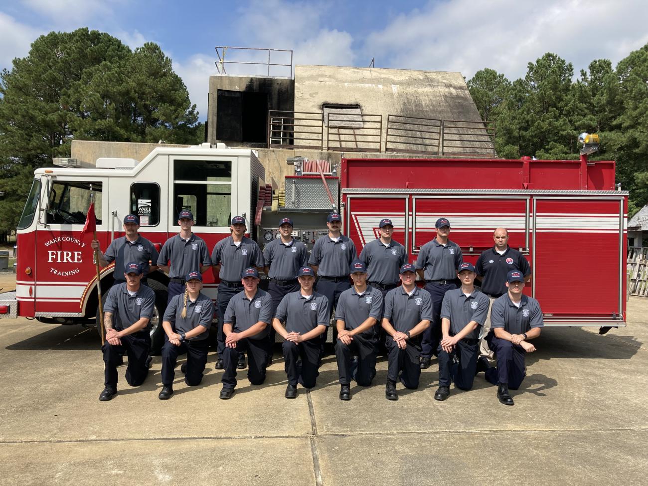 Wake County Fire Academy 13 recruits post in front of a fire truck