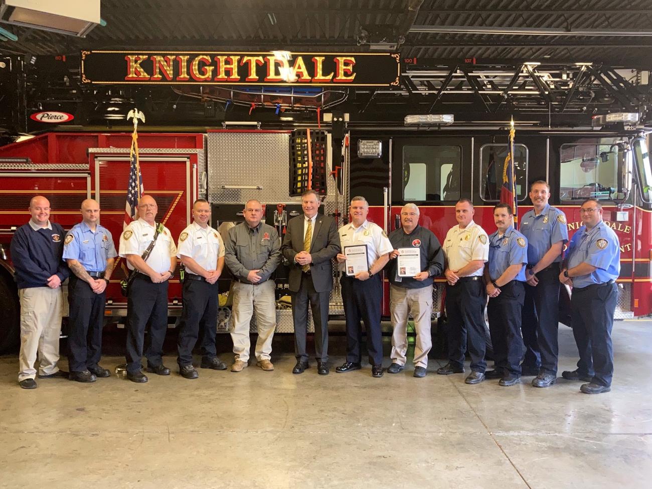Knightdale Fire Department staff and officials and Wake County Fire Marshal Darrell Alford pose before a Knightdale ladder truck