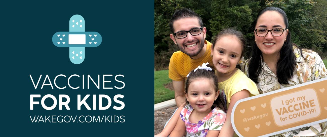 Latino family smiles with 'I got my vaccine for COVID-19' sign on Vaccines for Kids photo with crossed bandages