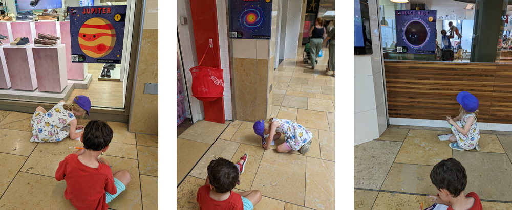 SpaceQuest posters in shop windows