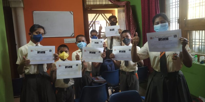 Moon Over Us astronomy club students from India, showing their certificates