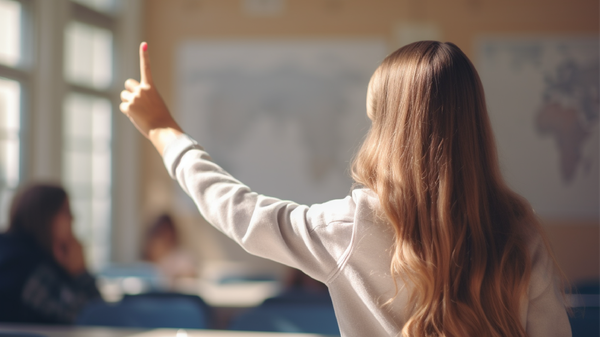 A student hold their finger out at arms length in front of them, as a way to see the parallax effect